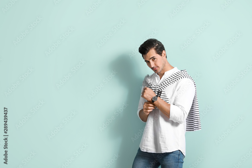 Stylish fashionable man on color background