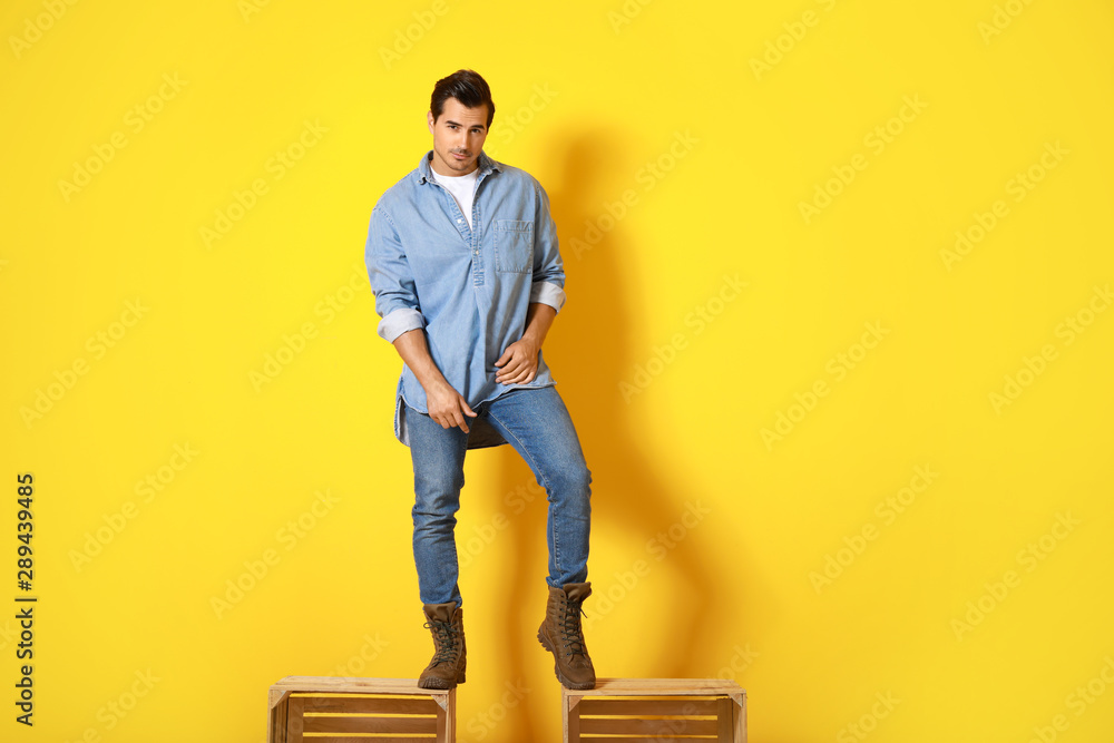 Stylish fashionable man on color background