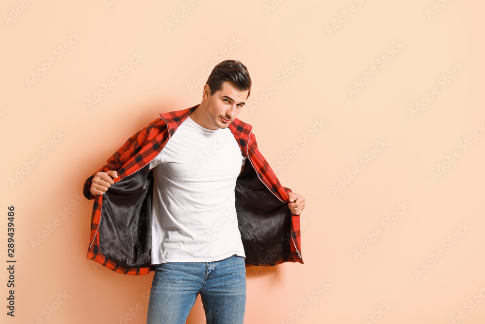 Stylish fashionable man on color background