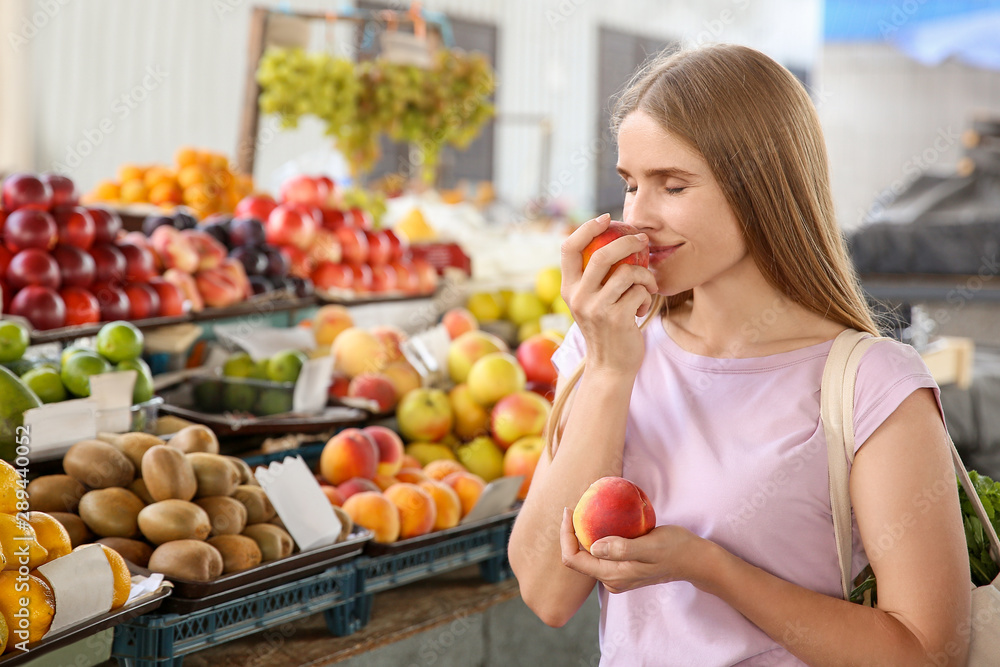 Woman choosing fruits at market