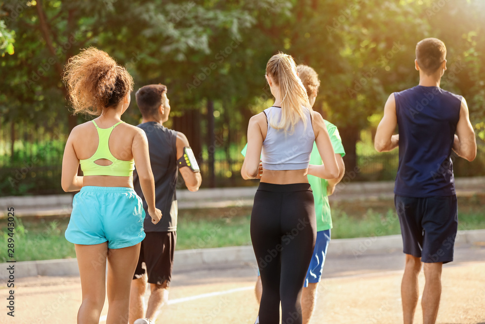 Group of sporty young people running outdoors