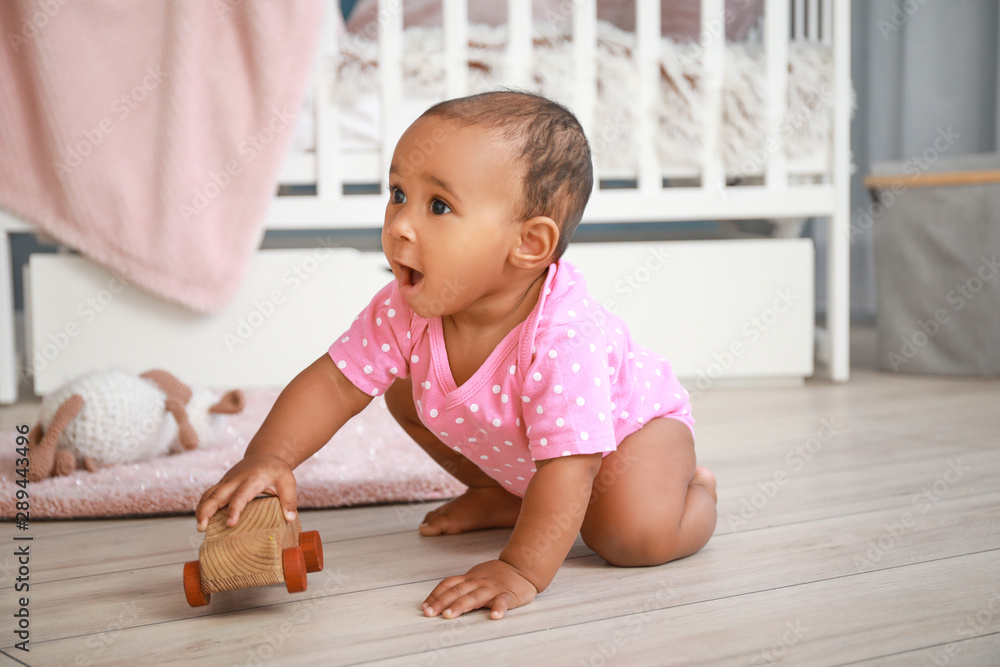 Cute African-American baby playing at home