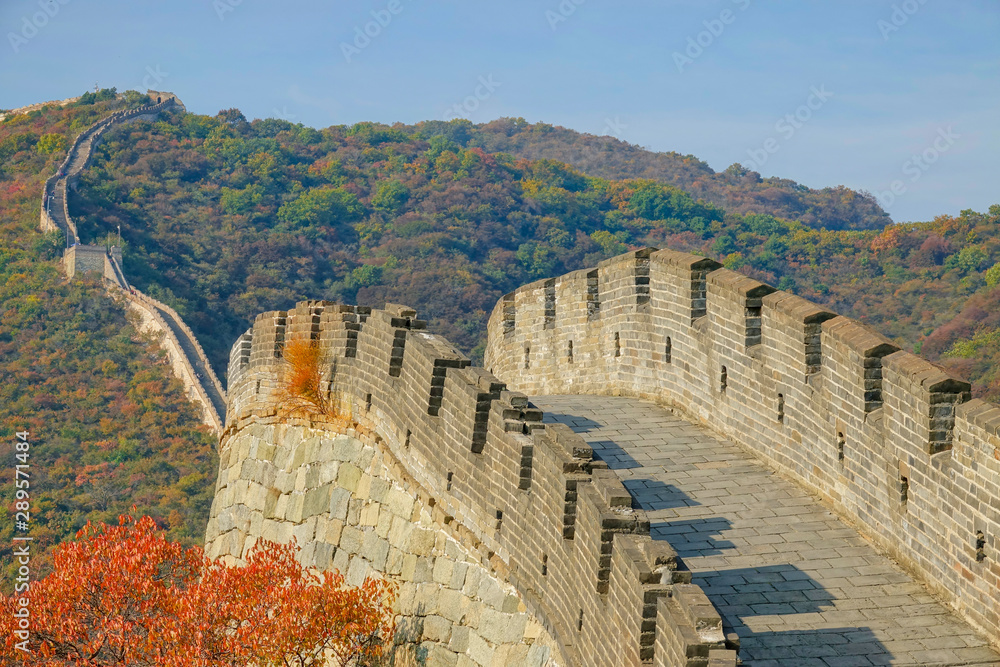 Scenic view of the cobblestone path on top of the Great Wall at golden sunset.