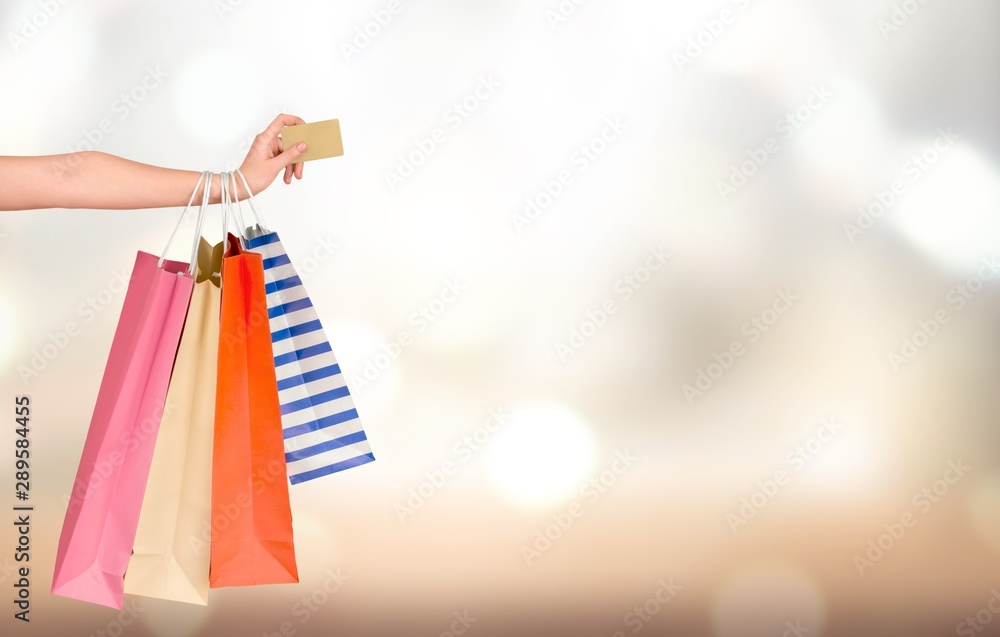 Close up woman hand with many shopping bags and credit card