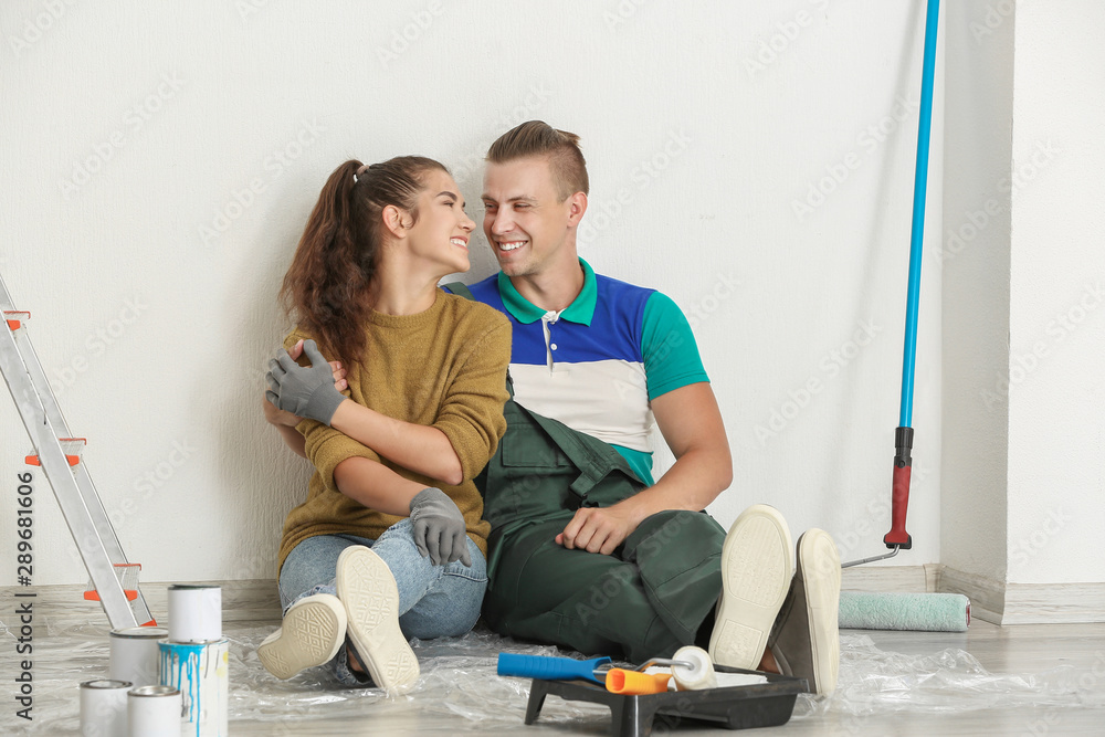 Happy young couple resting during repair of their new house