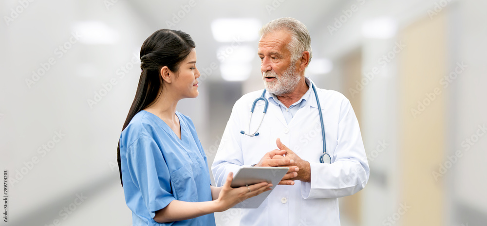 Senior doctor working with young doctor in the hospital. Medical healthcare staff and doctor service