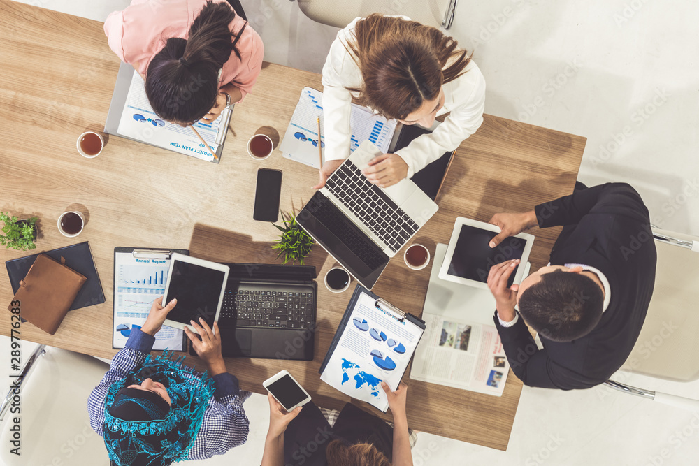 Top view of businessman executive in group meeting with other businessmen and businesswomen in moder