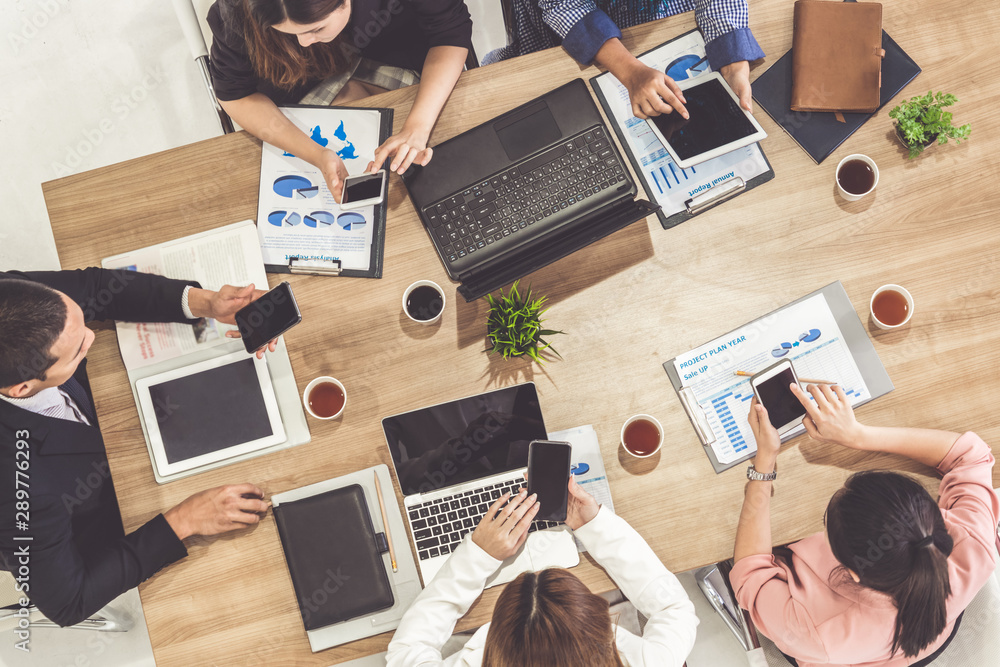 Top view of businessman executive in group meeting with other businessmen and businesswomen in moder