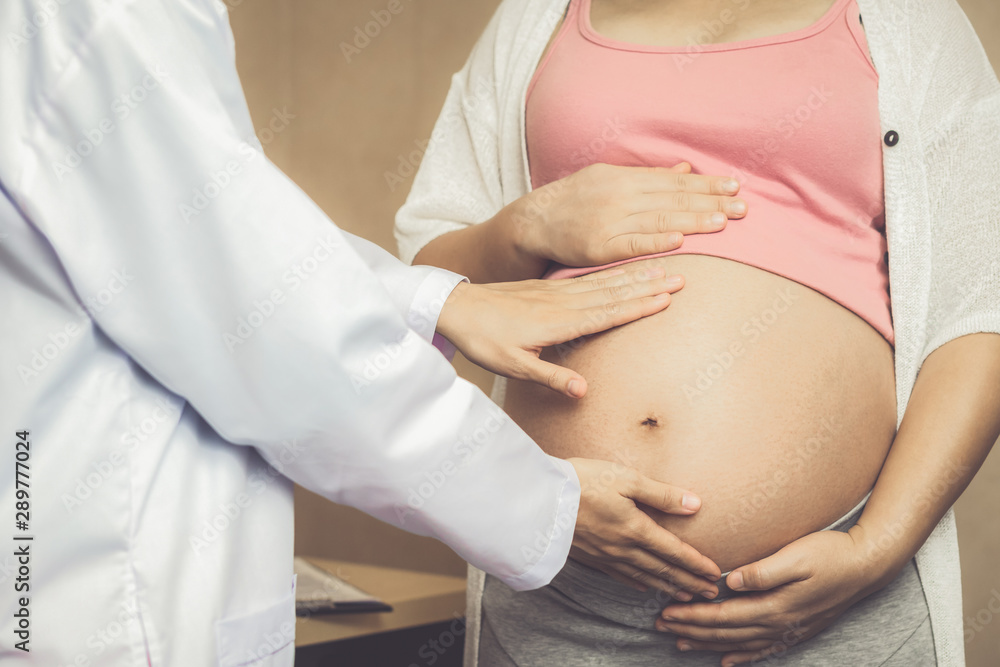 Happy pregnant woman visit gynecologist doctor at hospital or medical clinic for pregnancy consultan