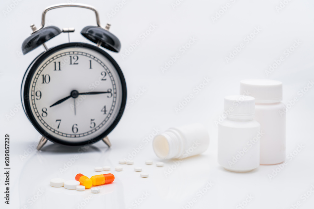 Pills, capsules and alarm clock