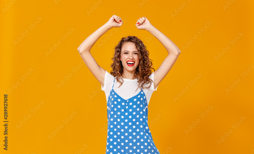 beautiful funny girl on colored yellow background.