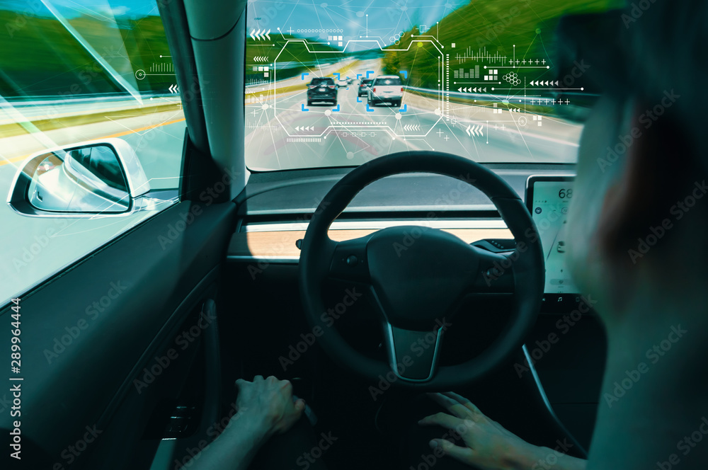 Person in a self driving autonomous car with autopilot