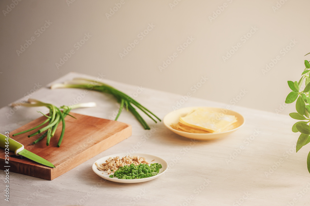 Wrapping Wonton and raw ingredients isolated at kitchen