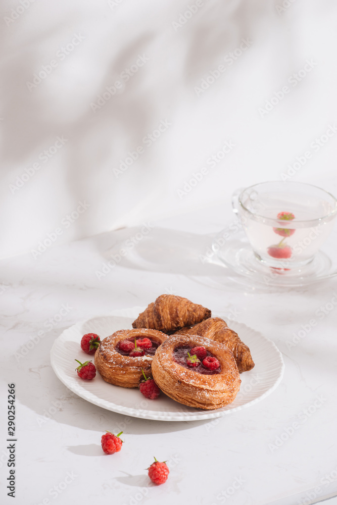 Raspberry filled pastries with sugar sprinkles. Selective focus.