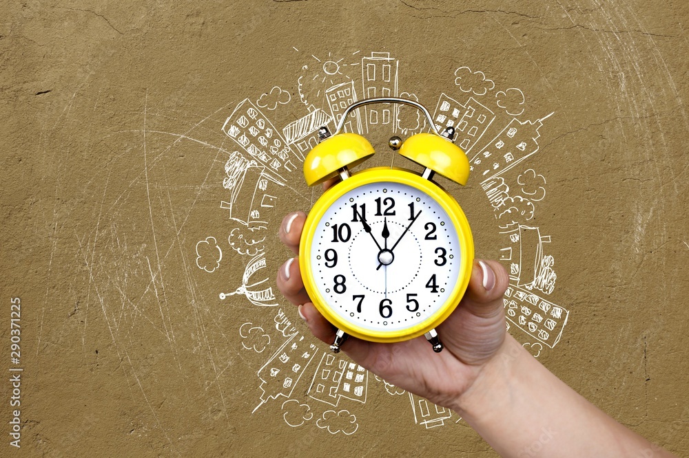 Woman holding alarm clock in hand isolated on background