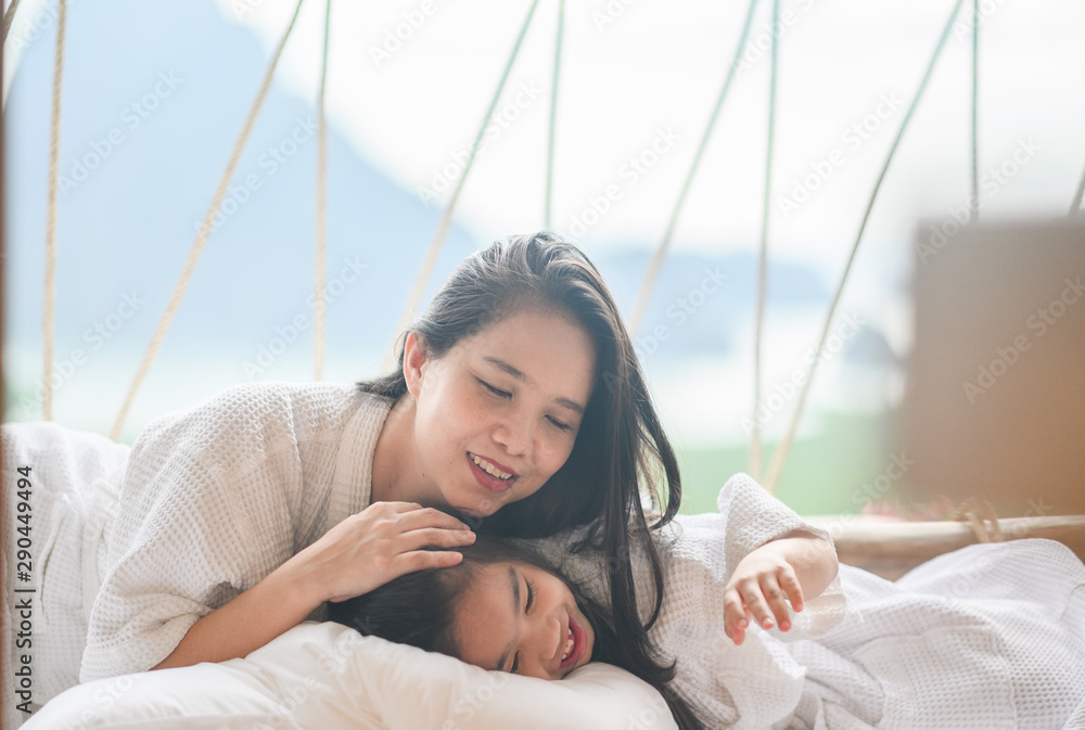  girl and her mother enjoy sunny morning. Good time at the nature background of the valley