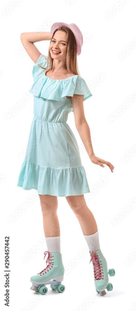 Beautiful young woman on roller skates against white background