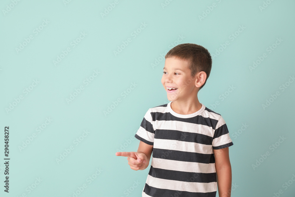 Portrait of happy little boy on color background