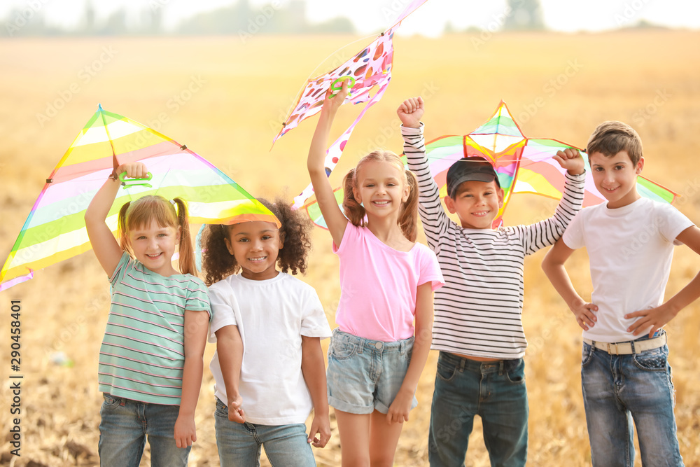 Little children flying kites outdoors