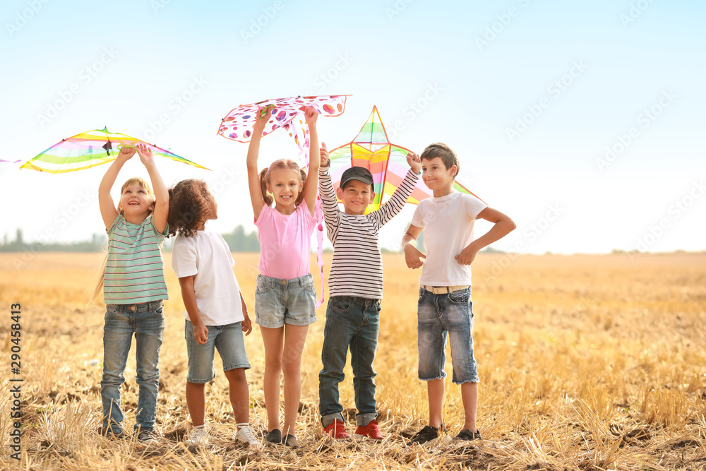 Little children flying kites outdoors