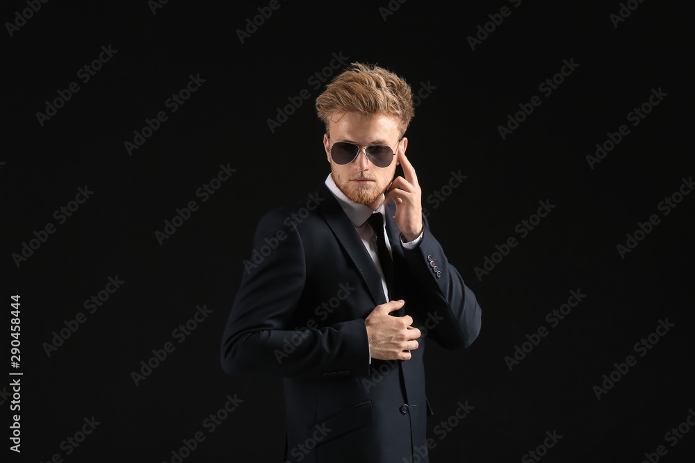 Handsome security guard on dark background