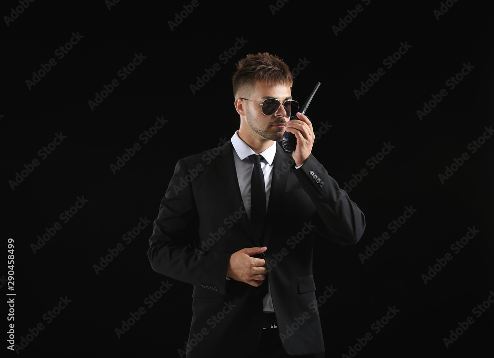 Handsome security guard on dark background