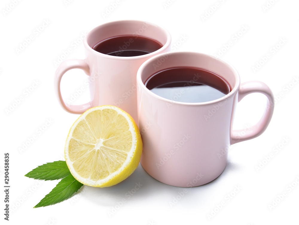 Cups of hot tea with lemon on white background