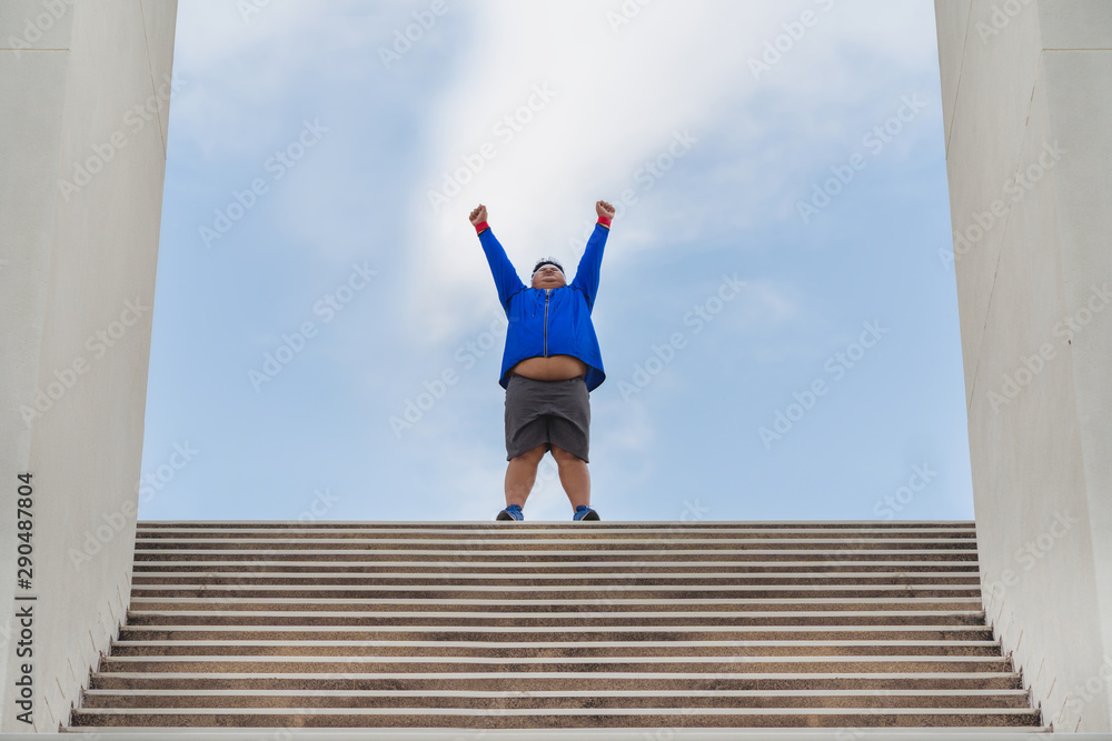 Fat man running up the stairs He succeeded in running.