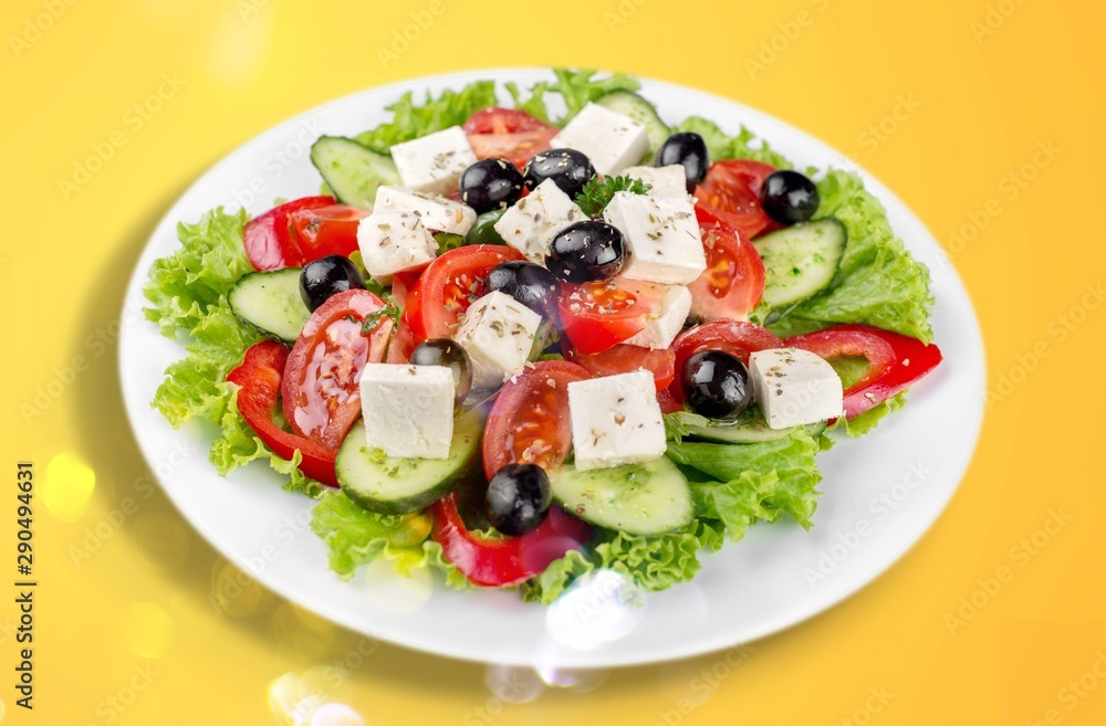 Greek salad with fresh vegetables on background