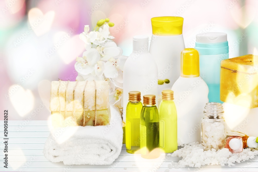 Bath towel and basket with accessories for spa on blur background