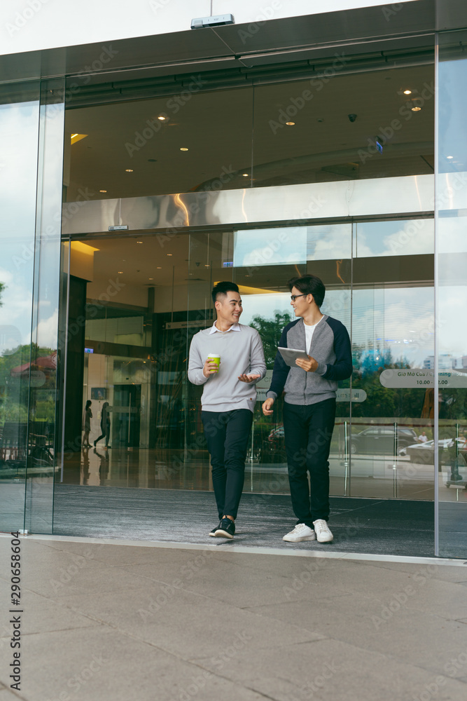 Young business people is walking and relax smile with city background