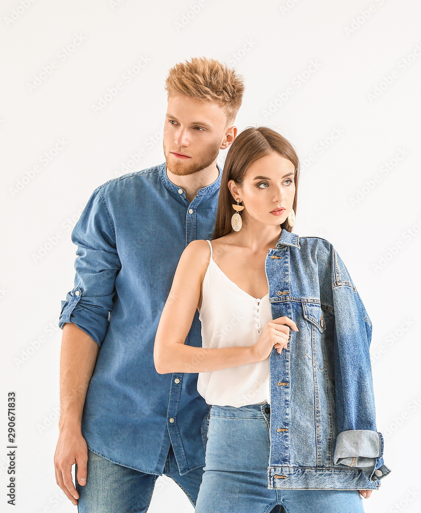 Fashionable young couple in stylish casual clothes on white background