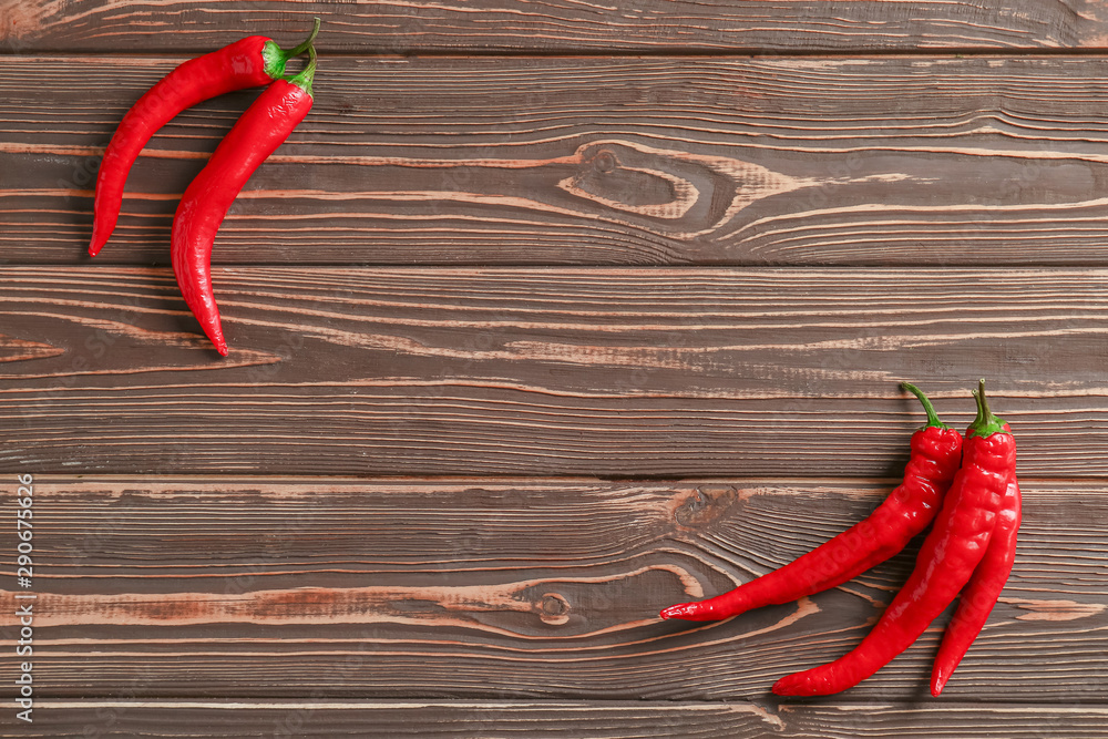 Fresh chili peppers on wooden background