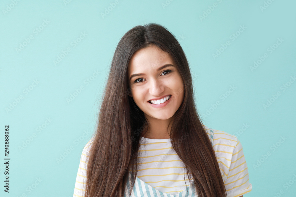 Portrait of happy young woman on color background