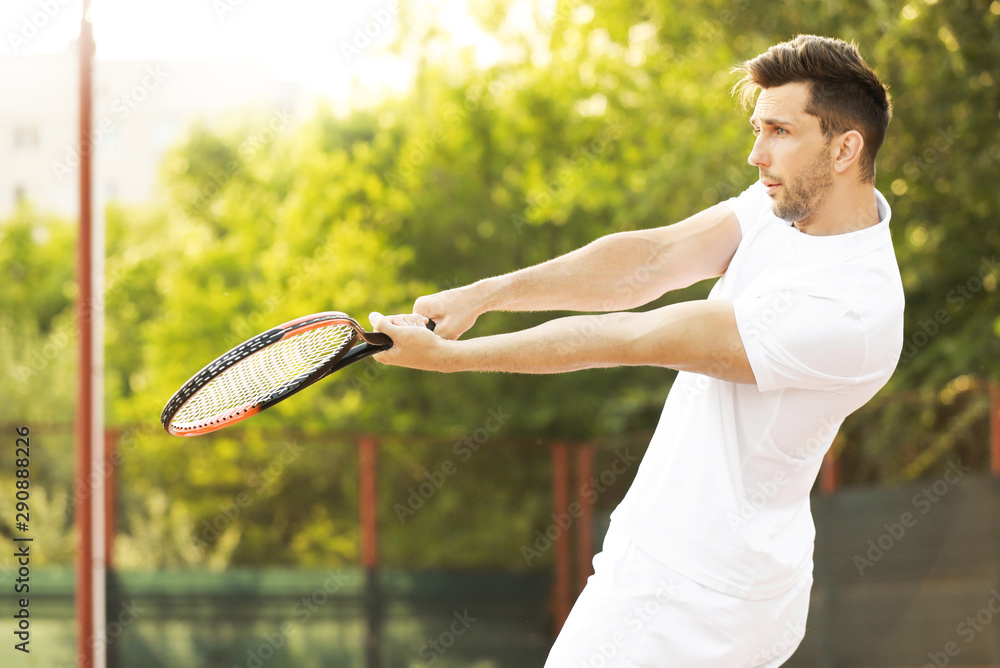 Young man playing tennis on court