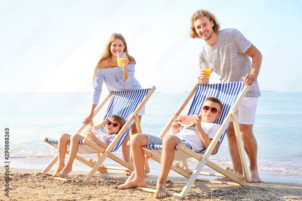 Happy family resting on sea beach