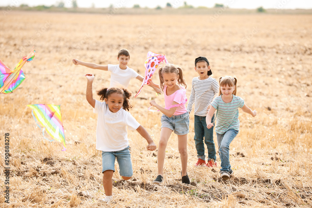 Little children flying kites outdoors