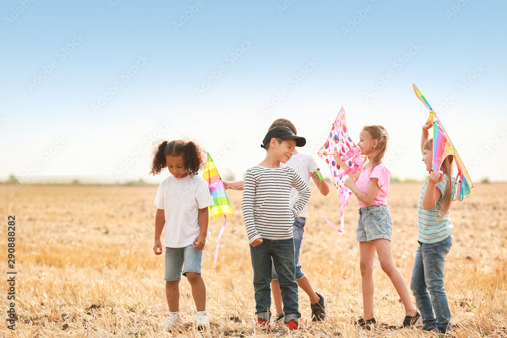 Little children flying kites outdoors