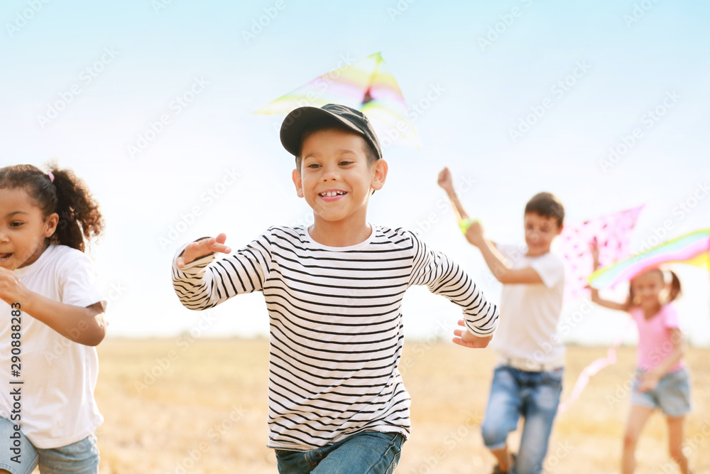 Little children flying kites outdoors