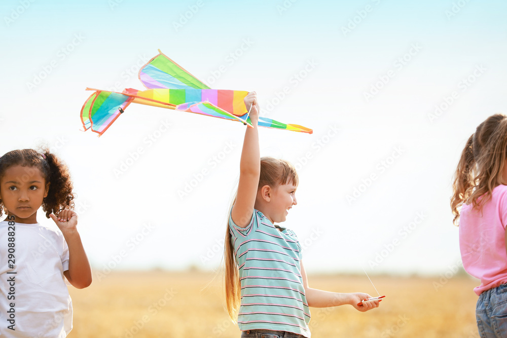 Little girls flying kite outdoors