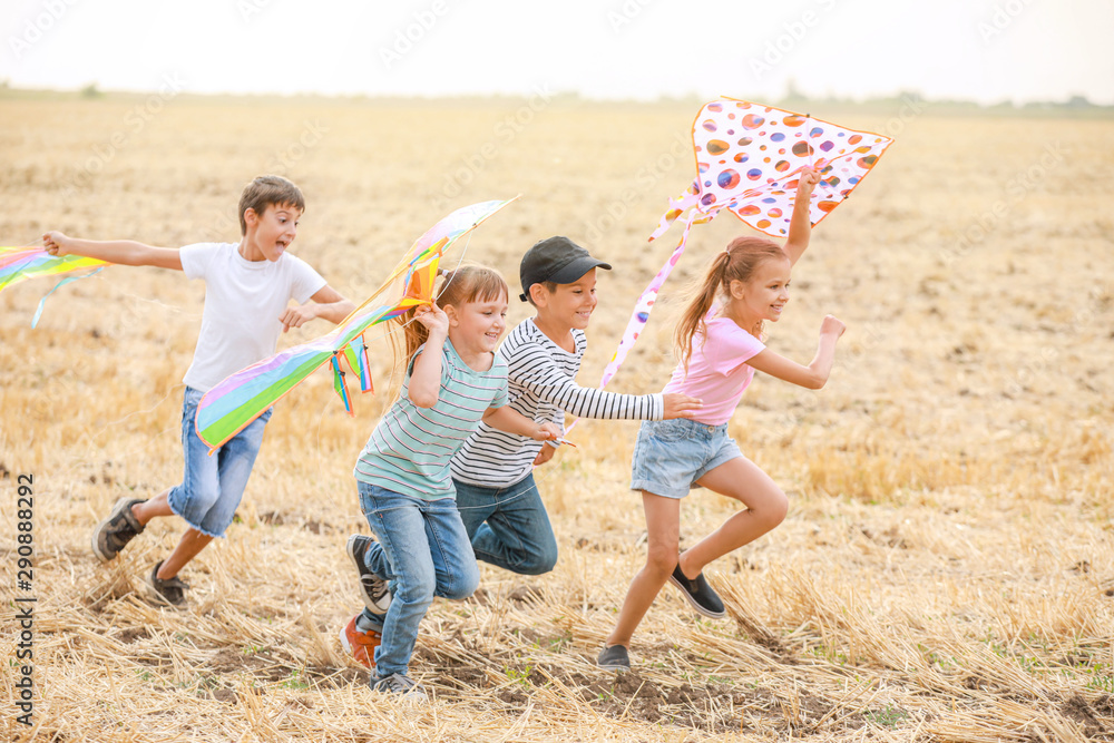 Little children flying kites outdoors