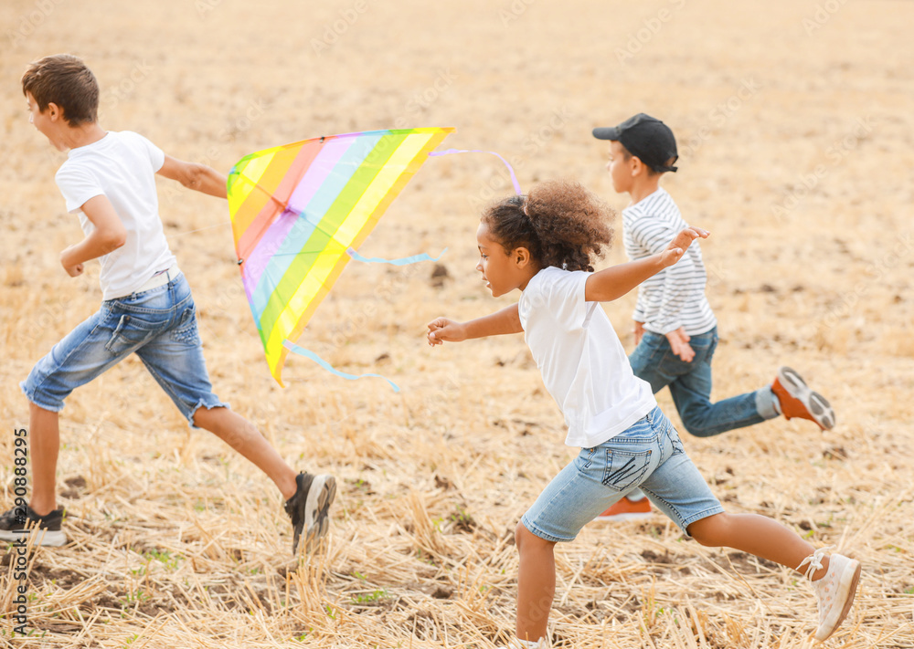 Little children flying kites outdoors