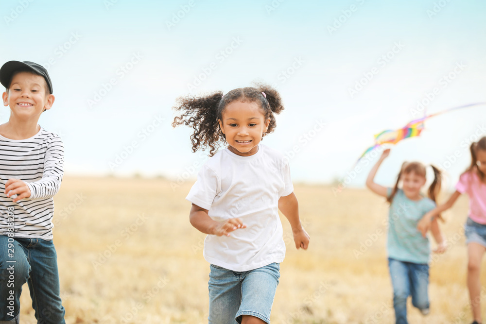 Little children playing in field