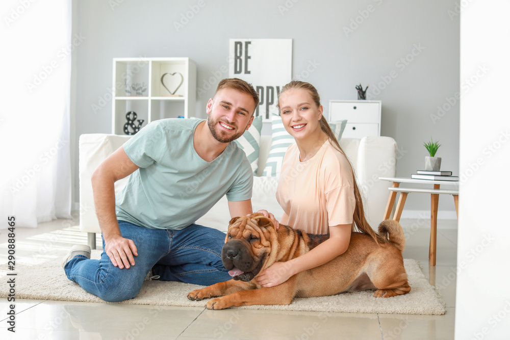 Happy couple with cute dog at home