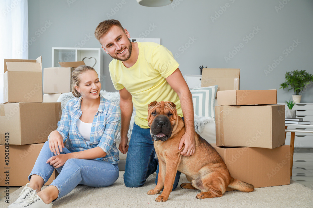 Happy couple with cute dog after moving into new house