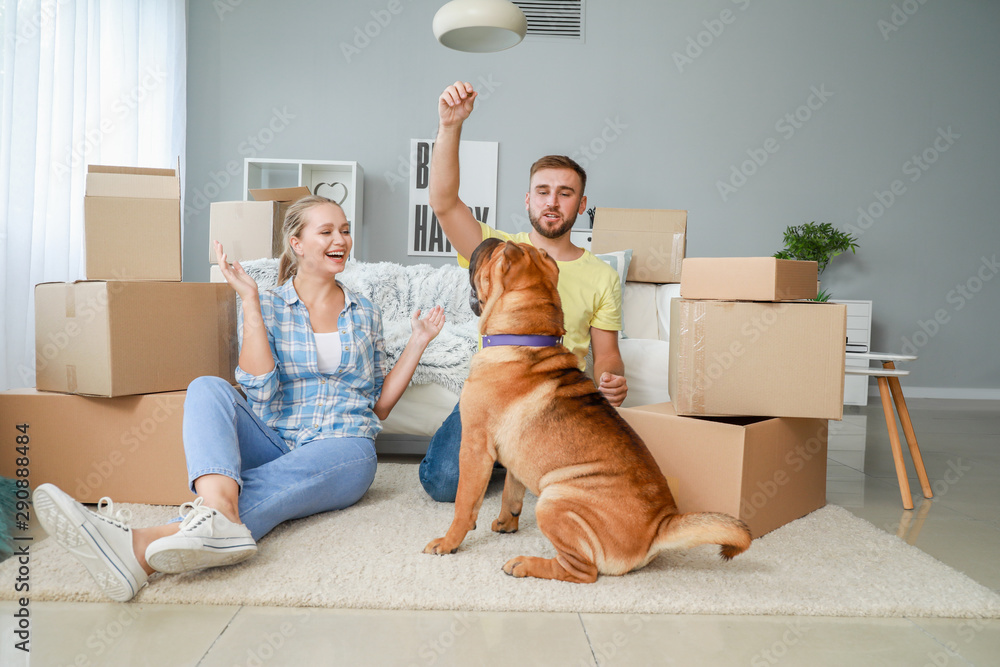 Happy couple with cute dog after moving into new house