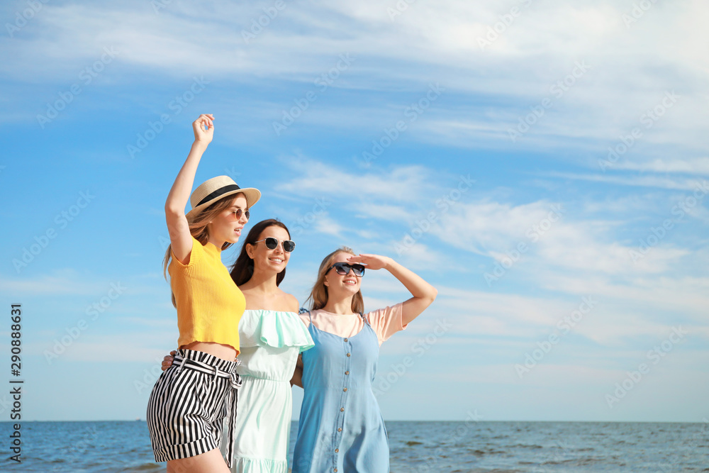 Happy young women on sea beach at resort