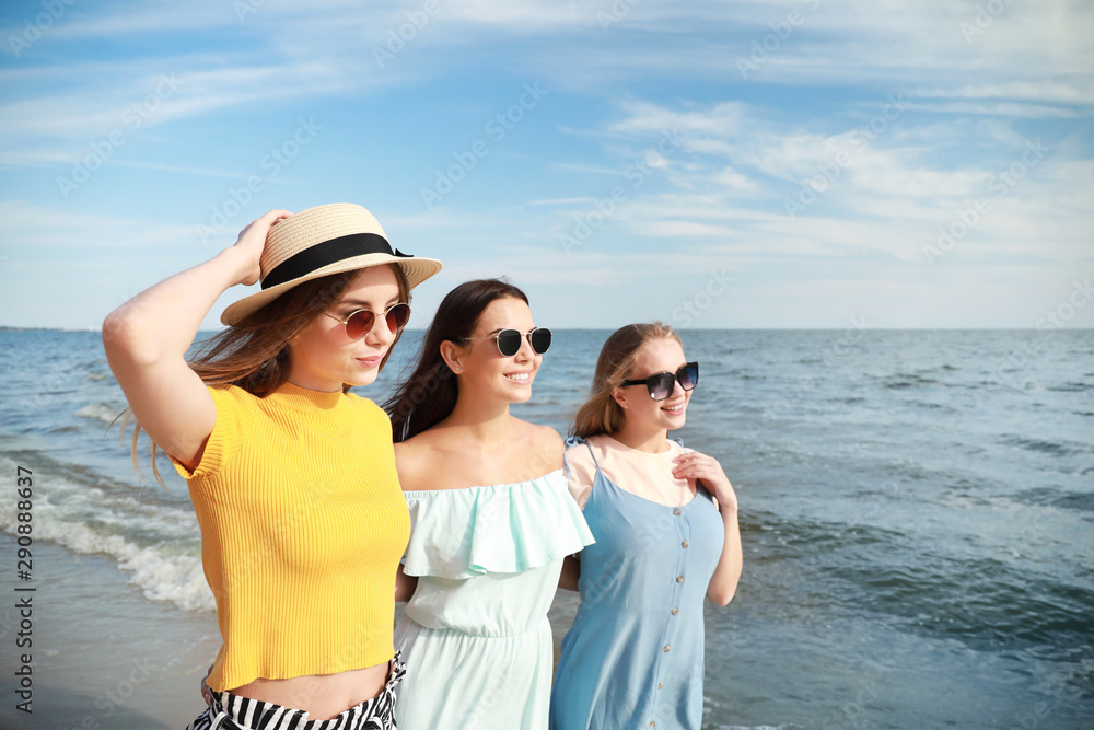 Happy young women on sea beach at resort