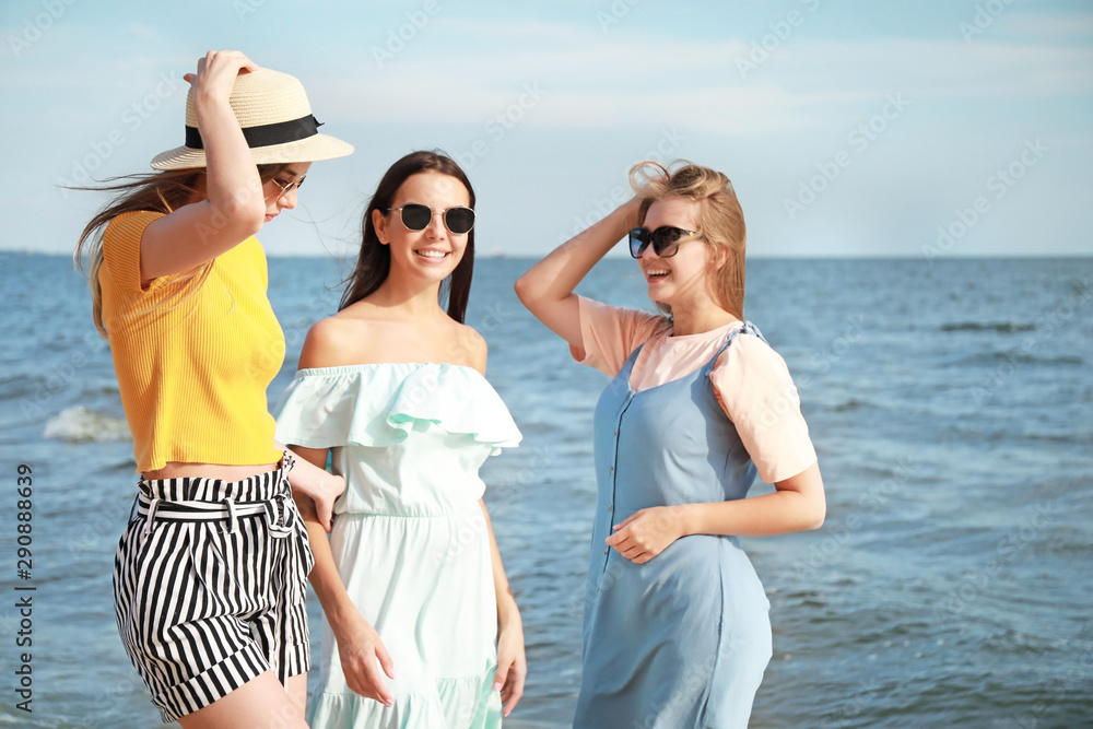 Happy young women on sea beach at resort