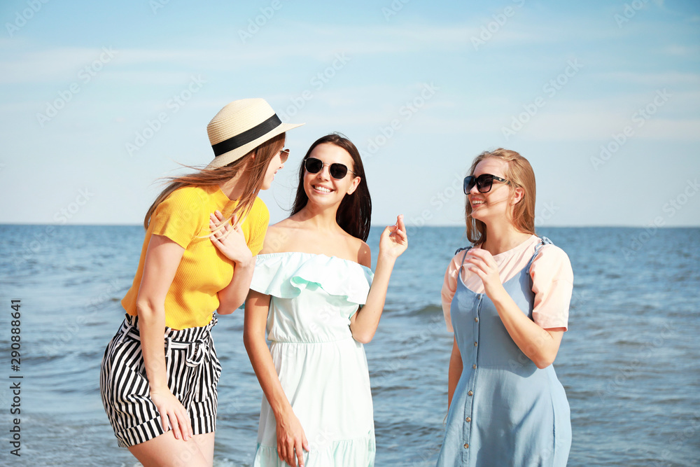 Happy young women on sea beach at resort